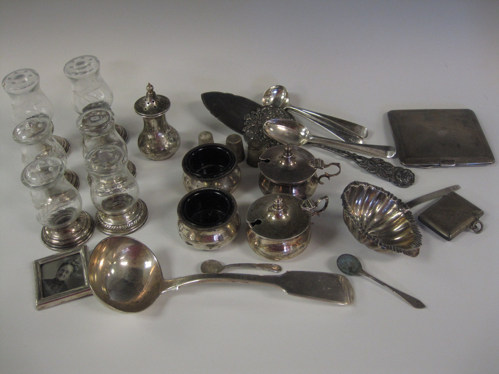 Six engraved glass Condiments with sterling silver bases and sundry silver items including Sauce