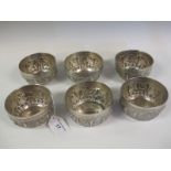 Six Eastern silver circular Bowls embossed frieze of figures and initial M within shield shape