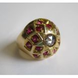 A Diamond and Ruby Bomb Ring set rose-cut diamond within sixteen brilliant-cut rubies, ring size N