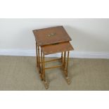 A nest of two satinwood Occasional Tables painted floral and musical designs, on four turned columns