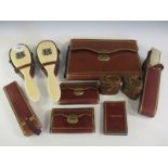 An Asprey's leather cased Dressing Table Set