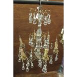 A French glass and brass six branch Chandelier with three tiers of glass drops