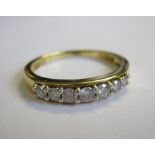 A Diamond seven stone Ring peg-set brilliant-cut stones in 18ct gold, ring size R 1/2