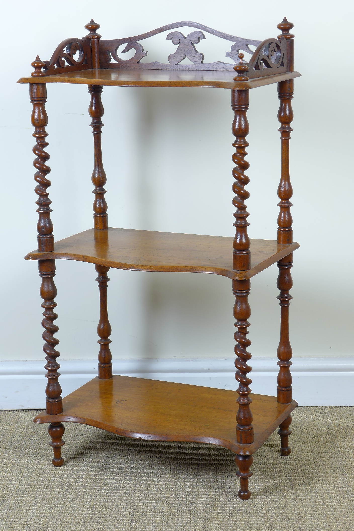 A Victorian walnut three tier Whatnot with serpentine front and spiral supports 3ft 1in H