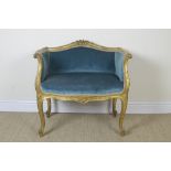A gilt framed Window Chair with carved cresting rail, scroll shaped arms, upholstered in blue dralon