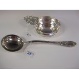 A Tiffany & Co silver heavy Porringer with single pierced flat section handle and a Continental