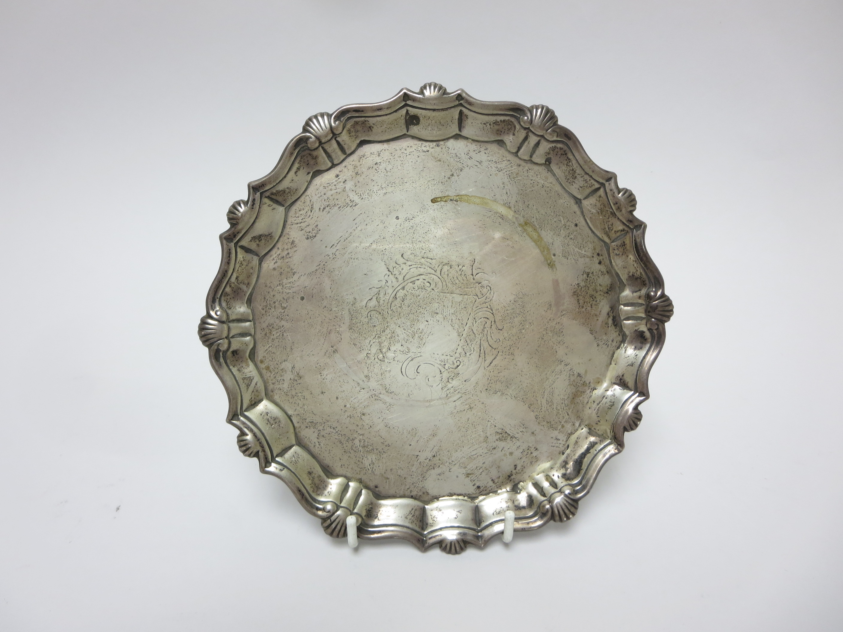 A George II silver Card Tray with shaped rim, engraved crest, on three pad feet, London 1740, 6 1/