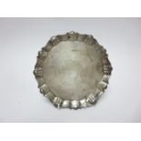 A George II silver Card Tray with shaped rim, engraved crest, on three pad feet, London 1740, 6 1/