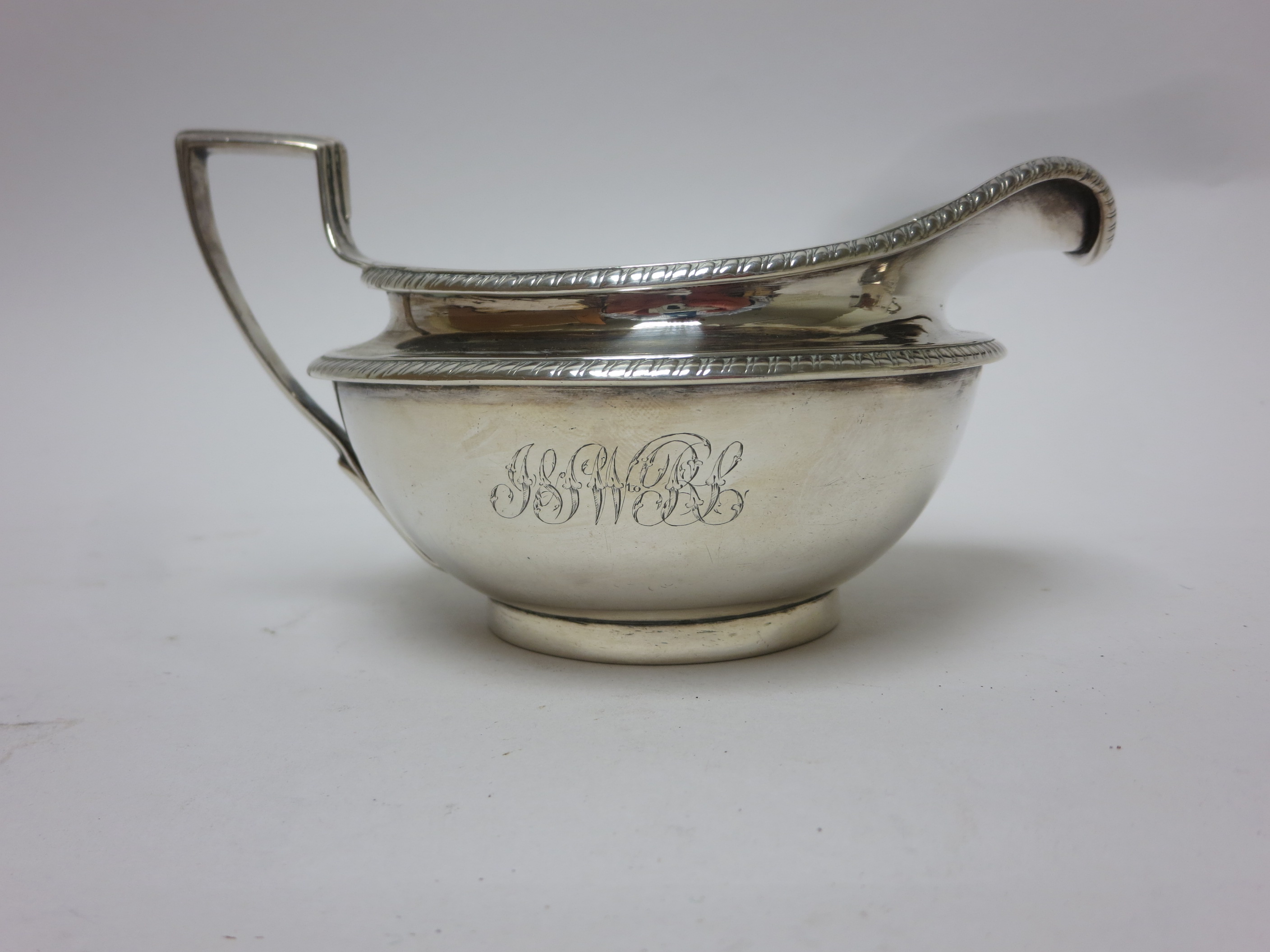 A George III silver Milk Jug of circular form engraved initials, London 1801, maker; J.E