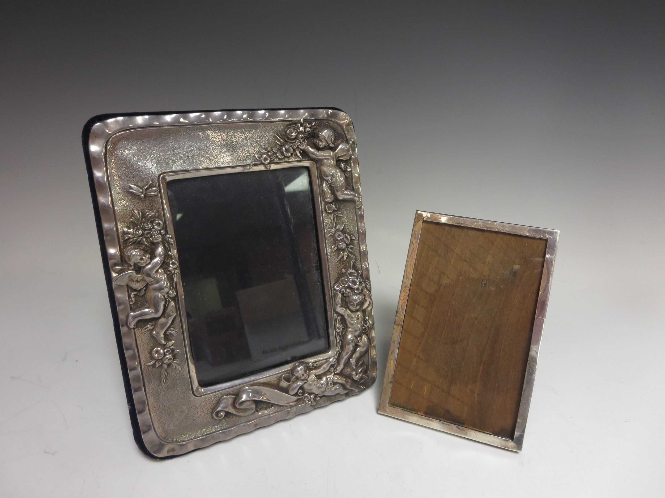 A modern silver Photograph Frame embossed cherubs and flowers, London 1988 and a small rectangular