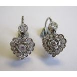 A pair of Diamond heart shaped drop Earrings each millegrain-set brilliant-cut stone within halo