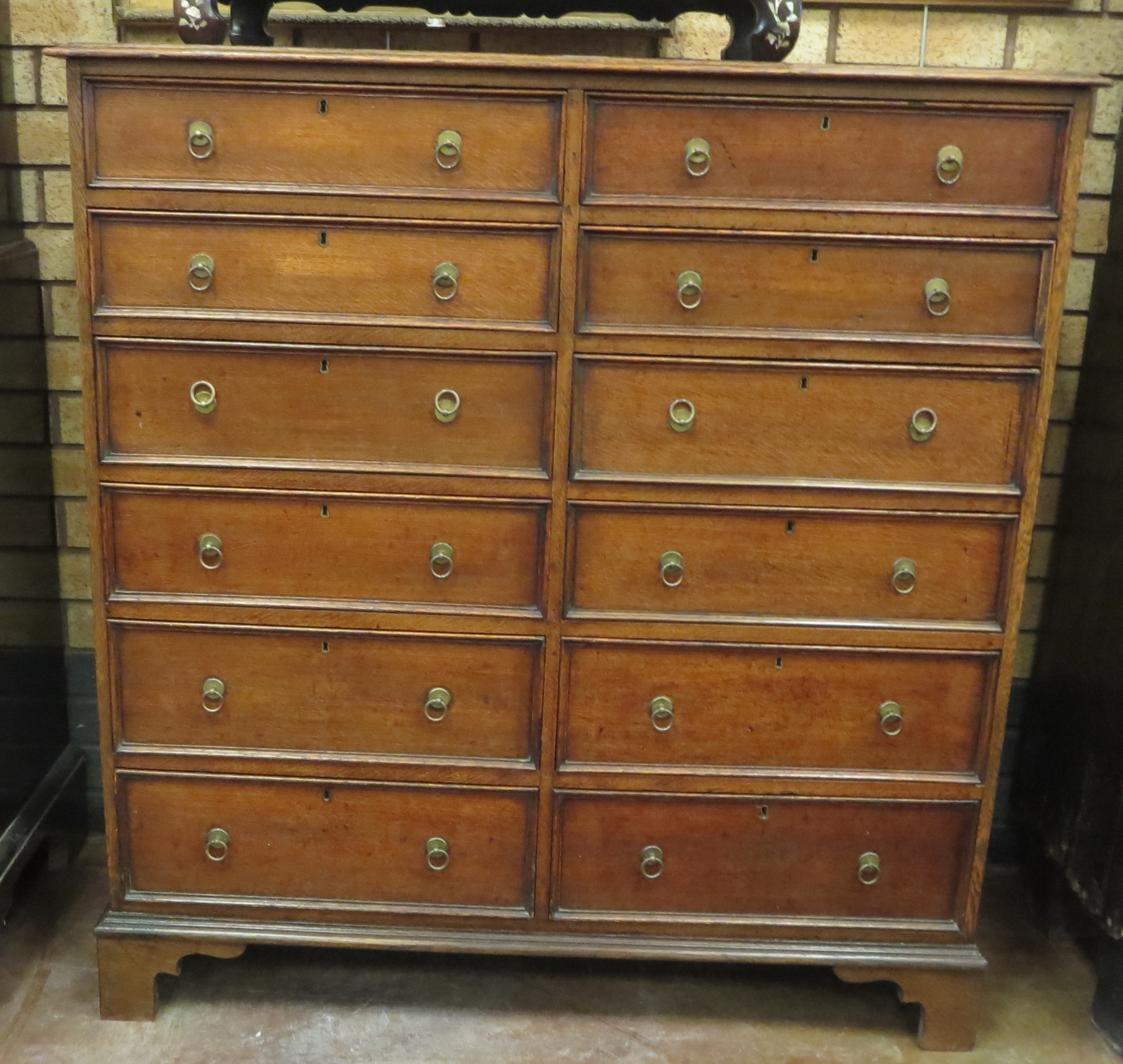 A 19th Century oak Chest of twelve narrow drawers on bracket feet, 3ft 6in W x 1ft 6in D