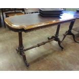 A Victorian walnut Side Table with leather inset top on cheval base, 4ft W x 1ft 10in D