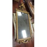 A Regency style gilt framed Wall Mirror with rose and ribbon surmount and rose decorated corners,