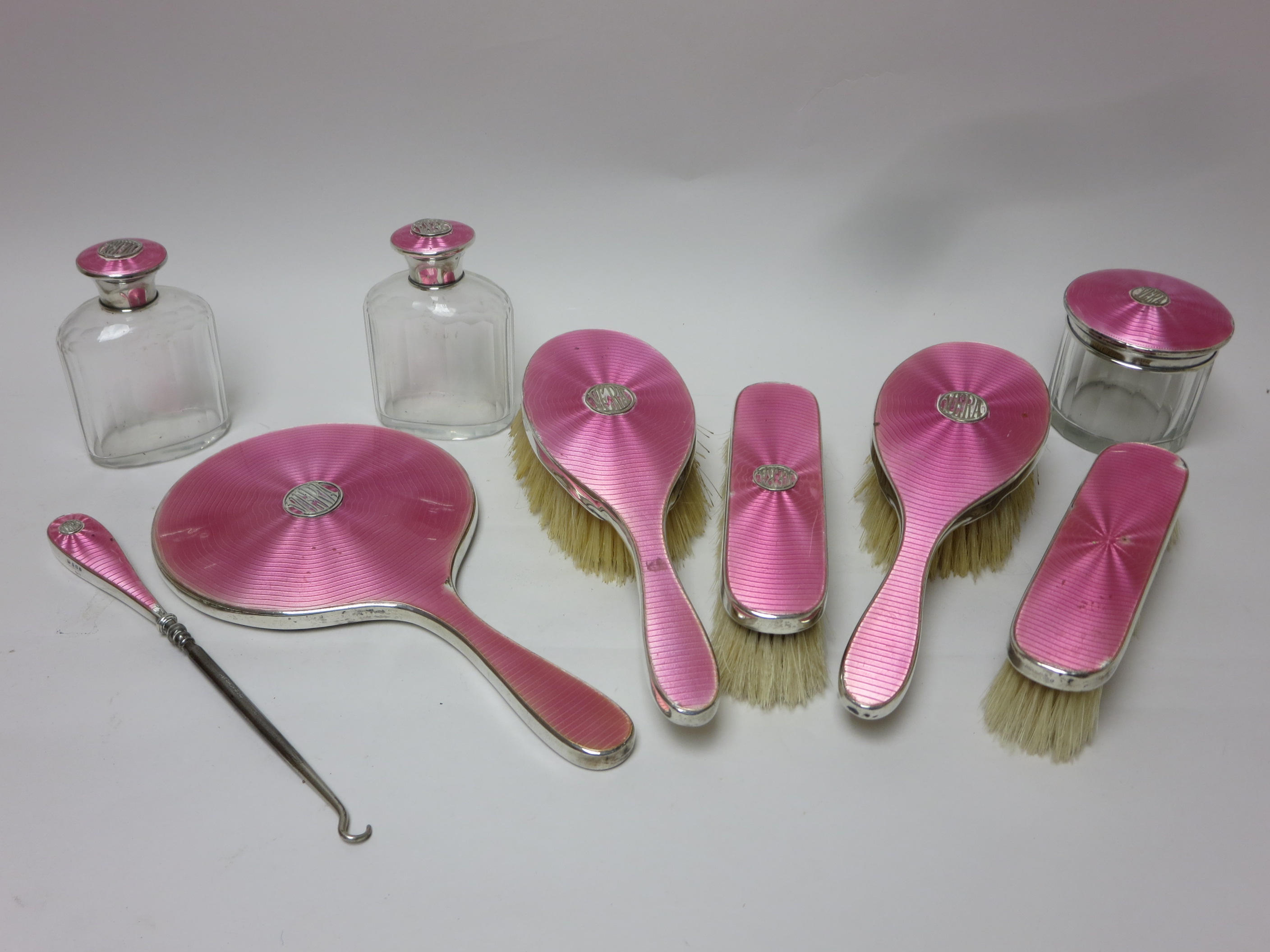 A George V silver and pink enamel Dressing Table Set named Vera, Birmingham 1924/5, 9 pieces