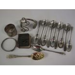 Ten white metal Teaspoons with spiral stems, engraved initials M.B., a small Georgian Berry Spoon,