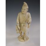 A Chinese carved ivory Figure of man carrying baskets, etc, lacks staff, 9 1/2in, signed