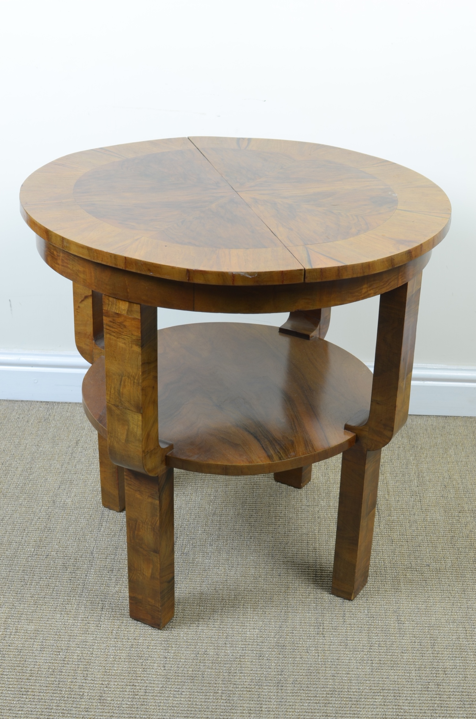 An Art Deco circular walnut Occasional Table with extending top, replaced leaf, with undertier,