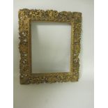 A carved giltwood Picture Frame, of pierced design with scrolls and foliage, inset size 20 x 16 in