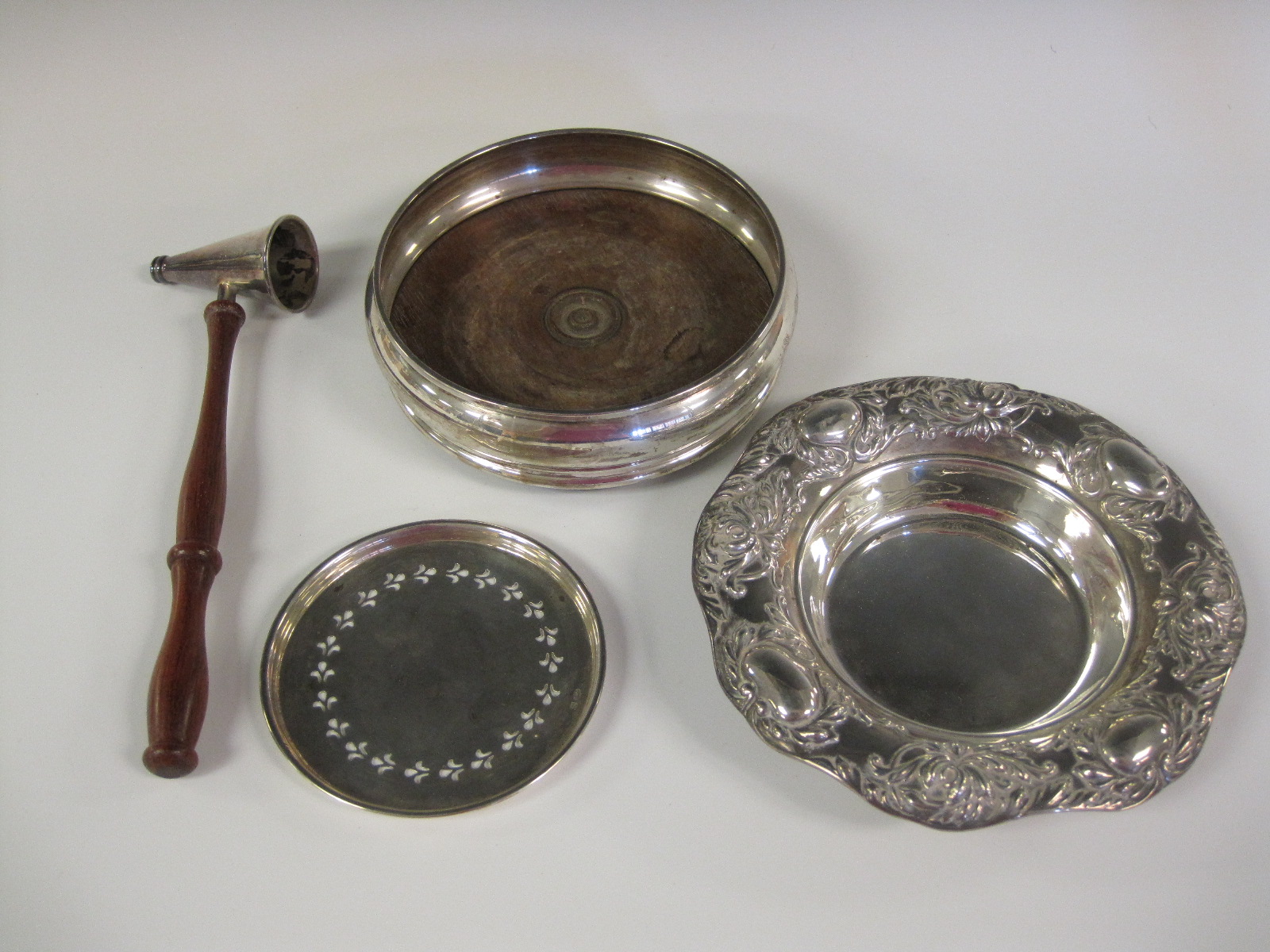 A modern silver Coaster with turned wooden base, London 1985, a Continental Dish and Strainer,