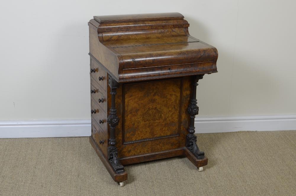 A Victorian burr walnut piano top Davenport with hinged stationary compartment, slide-out adjustable