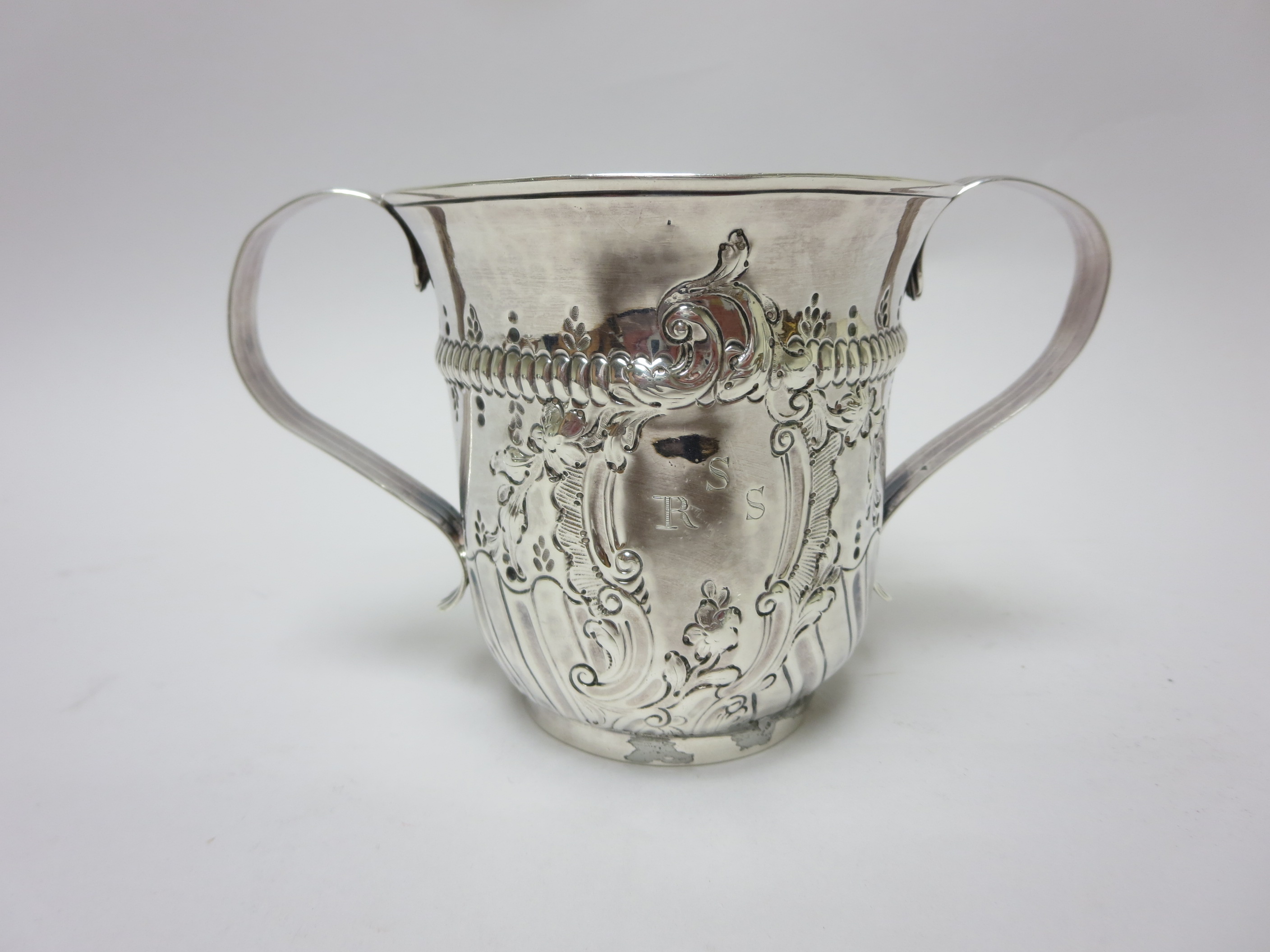 A George III silver two handled Porringer with gadroon and floral embossing, engraved initials,