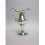 A George III silver pedestal Cream Jug with beaded rim, scroll handle, London 1774