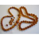 A graduated Amber Bead Necklace, some loose beads, approx 31.00 gms and another graduated amber type