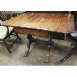 A Regency mahogany Sofa Table with brass inlay, drop leaves fitted frieze drawer on lyre cheval