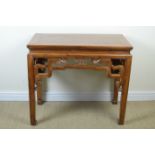 A Chinese hardwood Side Table with cleated top, having pierced and carved frieze on square supports,