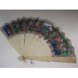 A 19th Century Canton Fan, the guards carved with figures in gardens, the leaf with courtiers,