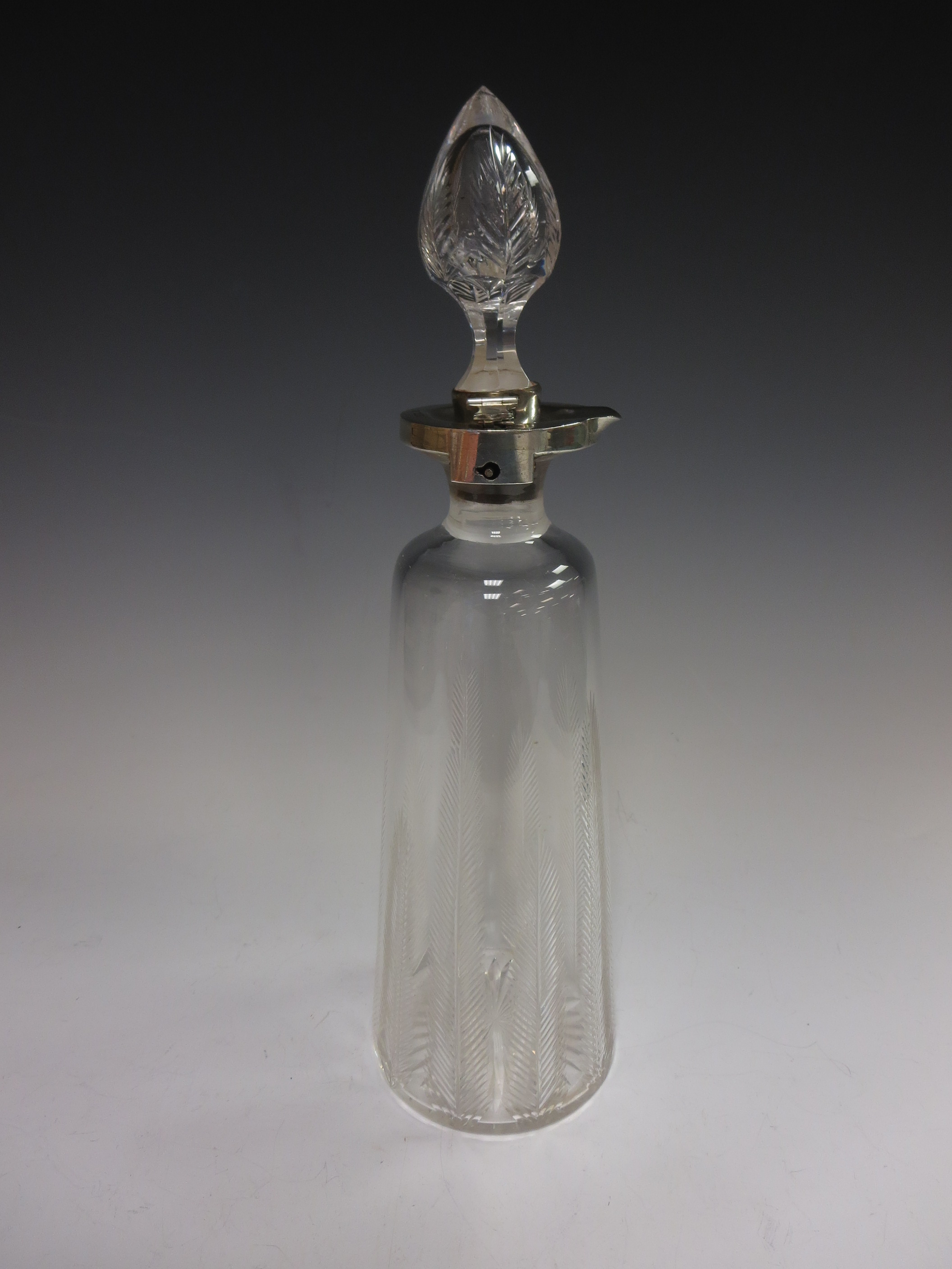 An Edward VII silver mounted cut glass Decanter with locking mechanism, leafage and star design,