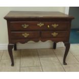 A George III oak Lowboy fitted one long and two short drawers on cabriole supports and pad feet (