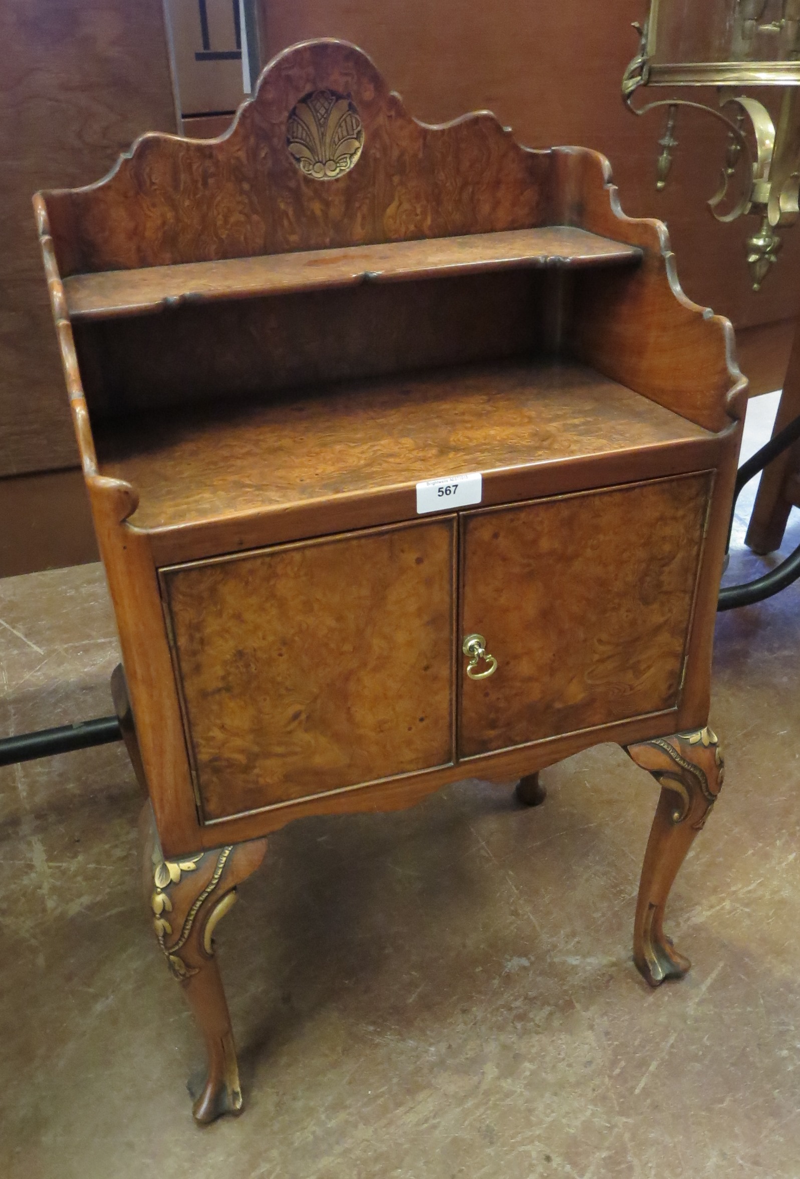 A Georgian style walnut Bedside Cabinet on cabriole supports with carved detail, fitted two small