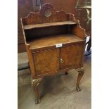 A Georgian style walnut Bedside Cabinet on cabriole supports with carved detail, fitted two small