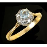 An Aquamarine and Diamond Cluster Ring claw-set circular-cut aquamarine within frame of eight