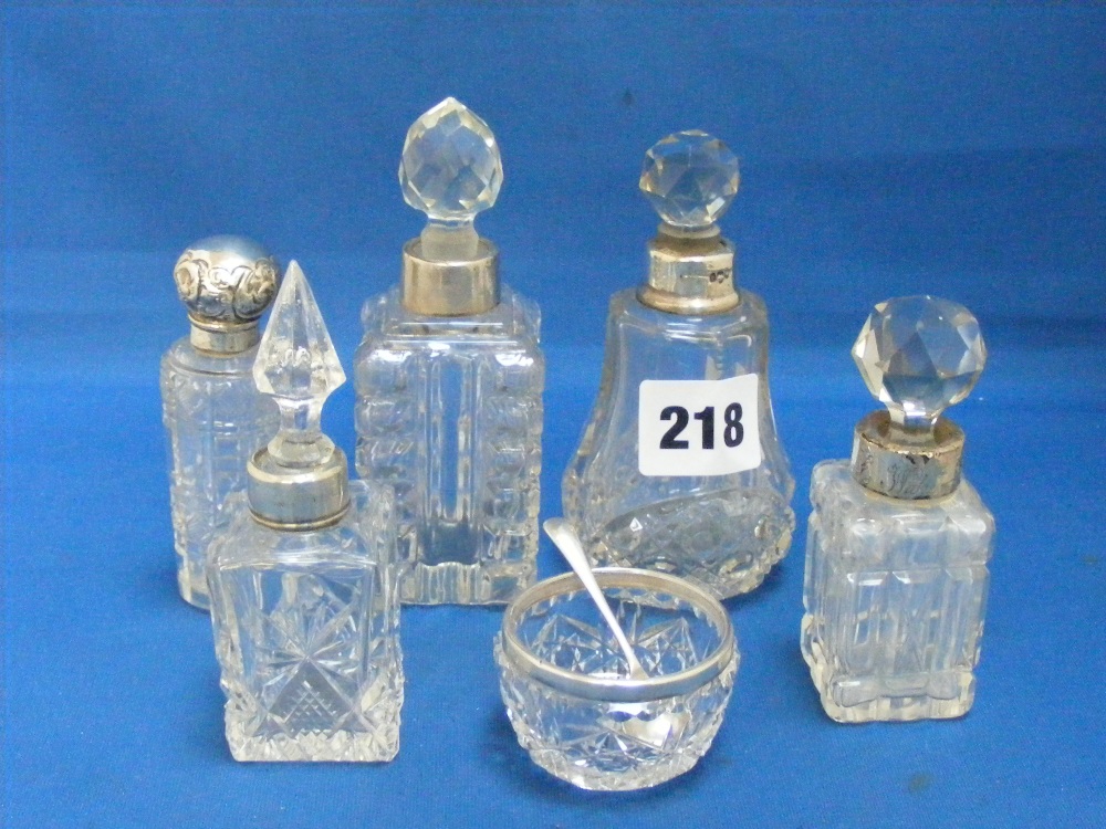 A collection of cut glass scent bottles