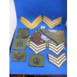 A collection of military cloth badges an