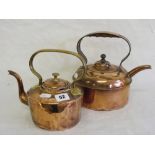 Two copper kettles, one having brass han