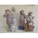 Three Nao figures of girls and boys in v