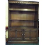 An Oak Three Shelf Bookcase with Cupboar