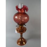 A Copper Oil Lamp with Coloured Glass Sh