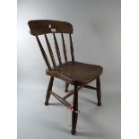 A Child's Elm Seated Spindle Back Chair
