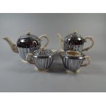 A Four Piece Chrome and Ceramic Tea Serv