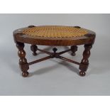 An Edwardian Oval Oak Cane Seated Stool.