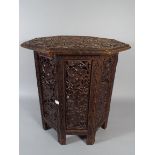 A 19 th Century Ornately Carved Octagonal Table with Folding Base, Vine and Grape Decoration.