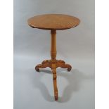 A 19 th Century Circular Topped Tripod Table with Scrolled Feet.