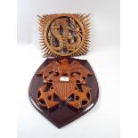 A Carved Wooden Armorial Crest from Haiti and A Balinese Carved Wooden Dragon with Pearl