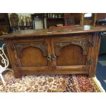 A Carved Oak Blanket Box with Cupboards and Lift Top.