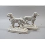 A Pair of Early 20th Century White Enameled Door Stops In The Form of St Bernard Dogs.